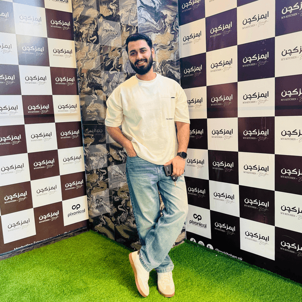 Dheeraj Ahuja standing in a cream T-shirt and jeans